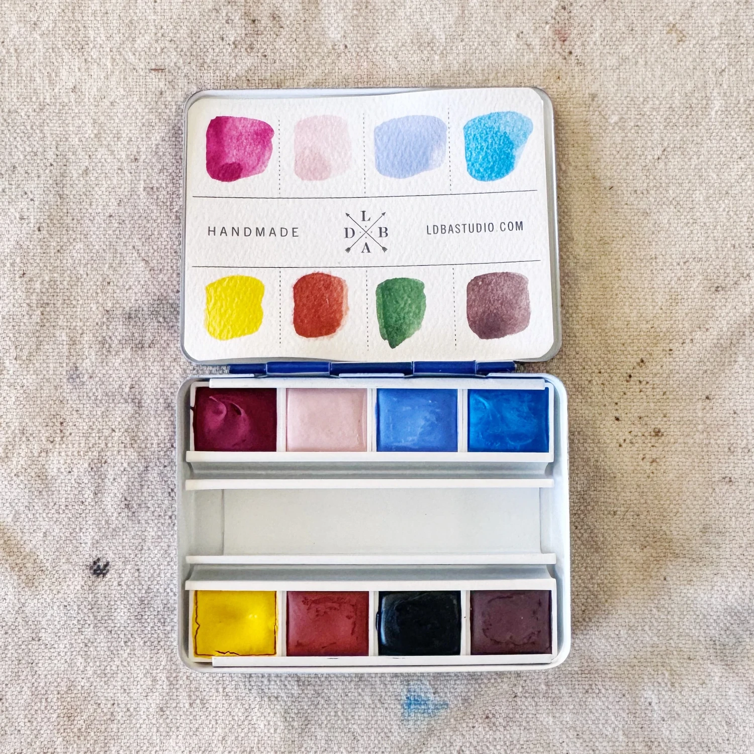 Sean Hudson's Sun & Shadow watercolor palette — 8 handmade paints in an Italian tin